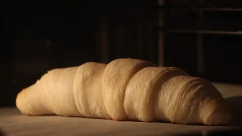 Timelapse of baking croissants in oven. Close-up view in 4K, UHD. Stock Footage 236832046