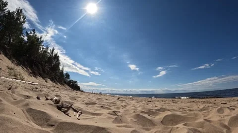 Timelapse of beach, clouds, sun, people walking by the Baltic sea Video stock 220975357