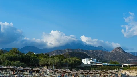 TIMELAPSE: Beach in Crete, against the backdrop of clouds in the mountains Stock Footage 101456465