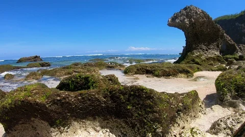 Timelapse of beach with sea waves splashing on rocky coast, Bali, Indonesia Stock Footage 140276002