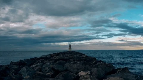 Timelapse of beacon on a jetty by the ocean Stockbeeldmateriaal 78734274