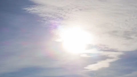 Timelapse of beautiful bright sun n spectrum in blue sky summer sunny cloudy day Stock Footage 169442198