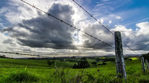 Timelapse Beautiful Clouds and Sun Behind Fence Farm Stock Footage 139122461