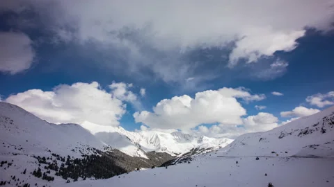 Timelapse - Beautiful Clouds Moving over Snowcapped Mountains Stock Footage 197096889