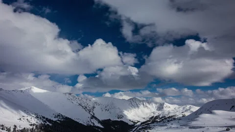Timelapse - Beautiful Clouds Moving over Snowcapped Mountains Stock Footage 222665044