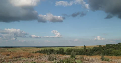 Timelapse of beautiful clouds over rolling hills, sunny day Stock Footage 253489638