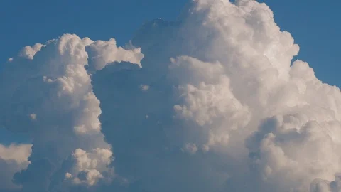 Timelapse: beautiful epic white clouds forming and moving in blue sky background Stock Footage 120505347