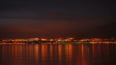 Timelapse. Beautiful evening sky over night city and sea. Stock Footage 88484244