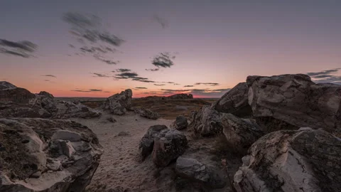 Timelapse beautiful sunset and the movement of clouds over boulders of rocks Stock Footage 247372927