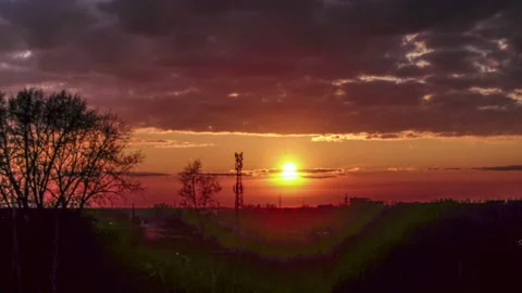 Timelapse of a beautiful sunset with clouds backlit by the sun Stock-Footage 129566555