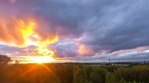 Timelapse of a beautiful sunset with clouds backlit by the sun Stock-Footage 129566686
