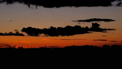 Timelapse of a beautiful sunset with clouds backlit by the sun Stock-Footage 129567021