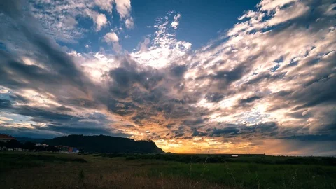 Timelapse of a beautiful sunset with rapidly moving clouds and the sun's rays Stock Footage 126645935