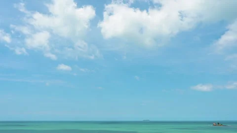 Timelapse of the beautiful view at the island beach with ocean waves and clouds. Stock Footage 248945992