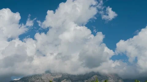 Timelapse of beautifully swirling clouds over a mountain peak Stock Footage 208043116