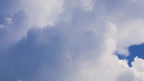 Timelapse of big white clouds moving fast in rays of sunlight. Stock Footage 278030748