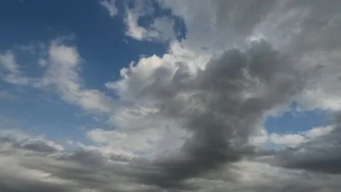 Timelapse of black and white clouds in the blue sky Stock Footage 321282218