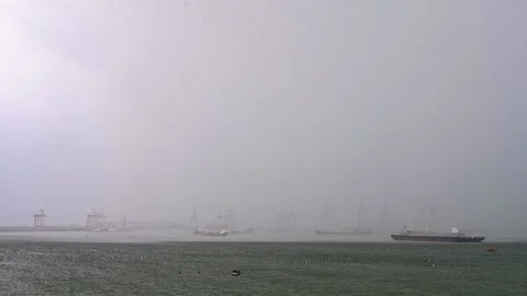 Timelapse. Black clouds and heavy rain are falling at the shipping port at du Stock Footage 136203635
