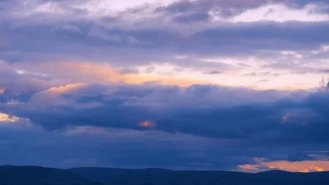 Timelapse of blue clouds over hills at sunset Stock Footage 116666335