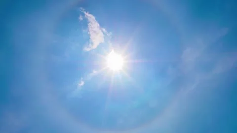 Timelapse of blue sky and expansive natural scenery with a sun halo Stock Footage 304219979
