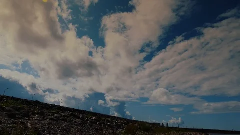 Timelapse in the blue sky over the dam across the Gulf of Finland flying clouds. Stock Footage 114980042