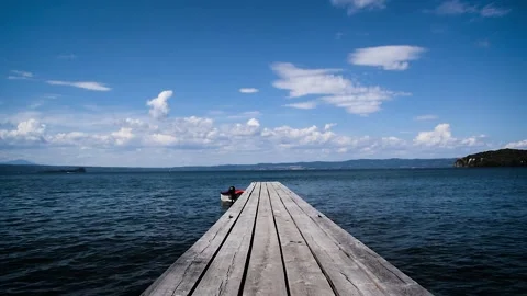 Timelapse of a boat tied to a dock on a lake, Full HD Stock Footage