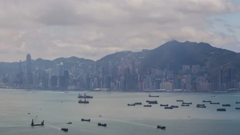 Timelapse boats sail on sea surface against Hong Kong city Stock Footage 118568950