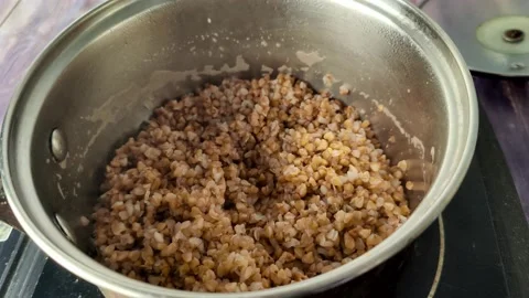 Timelapse of boiled buckwheat in a saucepan Stock Footage 231594014