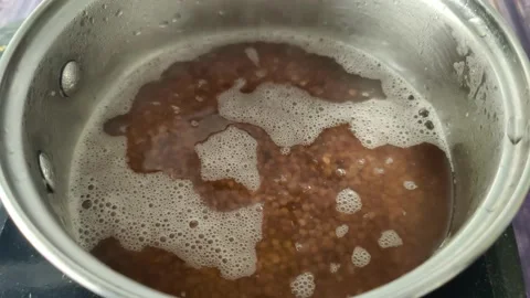 Timelapse of boiling boiled buckwheat in a saucepan Stock Footage 231594011
