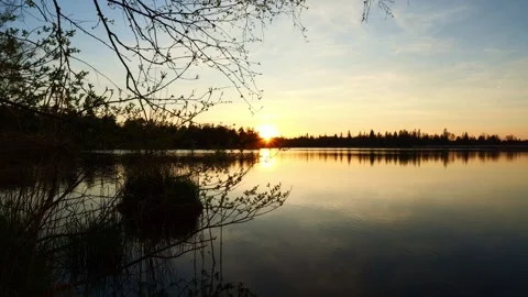 Timelapse of a Breathtaking Sunset Over the Serene Lake, Showcasing the Golde Stock Footage 309179960