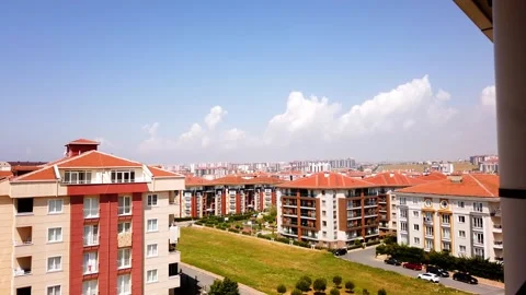 Timelapse. Bright blue sky. White clouds. Red tiled roofs of houses. Stock Footage 133355304