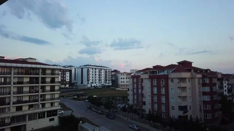 Timelapse. Bright blue sky. White clouds. Red tiled roofs of houses. Stock Footage 133355323