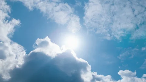 Timelapse bright sun on blue sky with moving fluffy clouds, sunny cloudscape Stock Footage 178680419