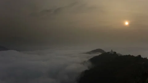Timelapse of Buddhist Stupa at sunrise with blue mist, like a sea Stock Footage 59067563
