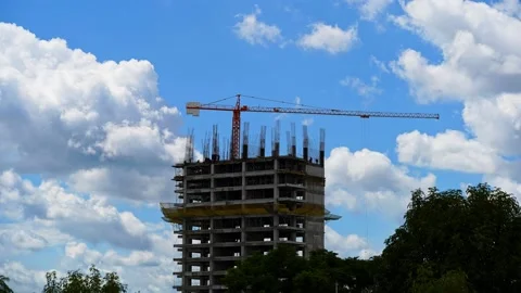 Timelapse of building crane with sunny clouds background Stock Footage
