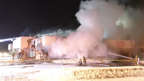 Timelapse of building fire with dense toxic colored smoke pouring out of roof Stock Footage 104514366