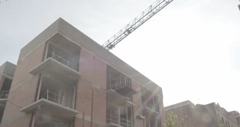 Timelapse building under construction with moving crane and pallet hook 4K Stock Footage 165597309