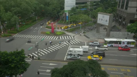 Timelapse of busy city intersection with yellow taxis and pedestrians in Taipei Stock Footage 323065882