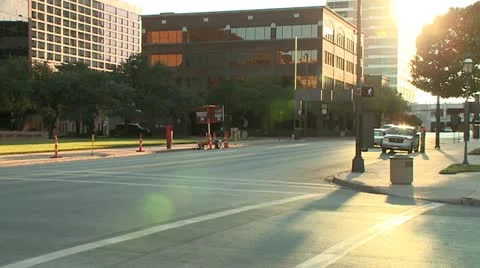 TIMELAPSE BUSY DOWNTOWN INTERSECTION WITH LENS FLARE Stock Footage 12731819