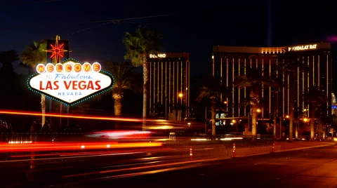 Timelapse of busy traffic light streaming past Welcome to Las Vegas Sign Stock Footage 51688198