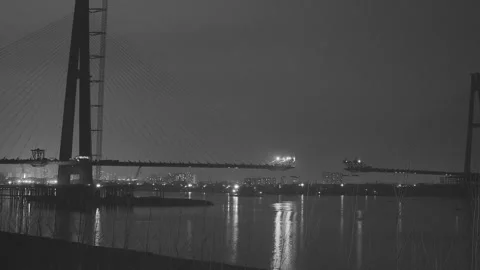Timelapse of Cable-Stayed Bridge Construction at Night Over River Stock-Footage 336823648