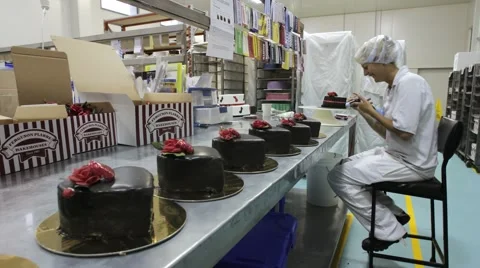 Timelapse of cake decorating at a commercial bakery Stock Footage 1087326