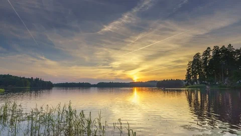 Timelapse of calm beautiful sunset over forest lake Stock Footage 104484748
