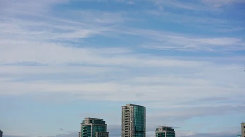 Timelapse calm evening sparse white clouds in sky over city Stock Footage 118130130