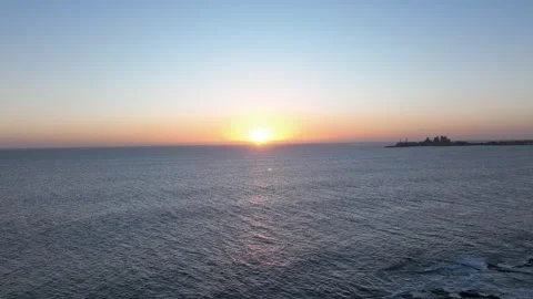 Timelapse of Calm Ocean Waves at Sunset with Pier in Distance Stock Footage 309950978