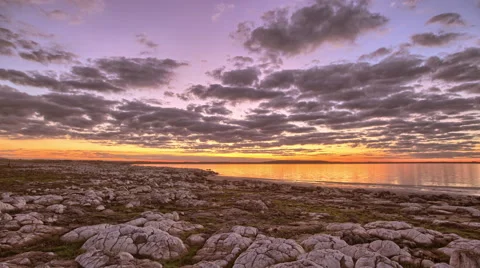 A timelapse camera tracks along a rocky landscape at sunset Stock Footage 57296008