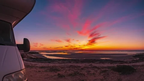 Timelapse: Camper van partial view during dramatic sunset, colorful clouds over Stock Footage 327315854