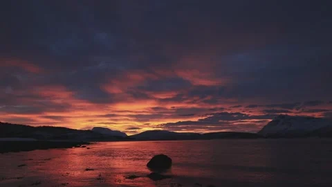 Timelapse captures a vivid Arctic sunset beyond Malangen fjord Stock Footage 319392962