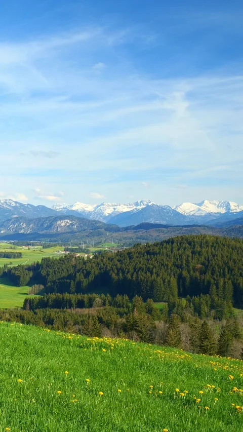 Timelapse capturing the movement of flowing clouds and distant mountain views Stock Footage 309227786