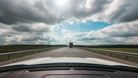 Timelapse of the car riding by speedway at sunny cloudy day Stock Footage 155582953
